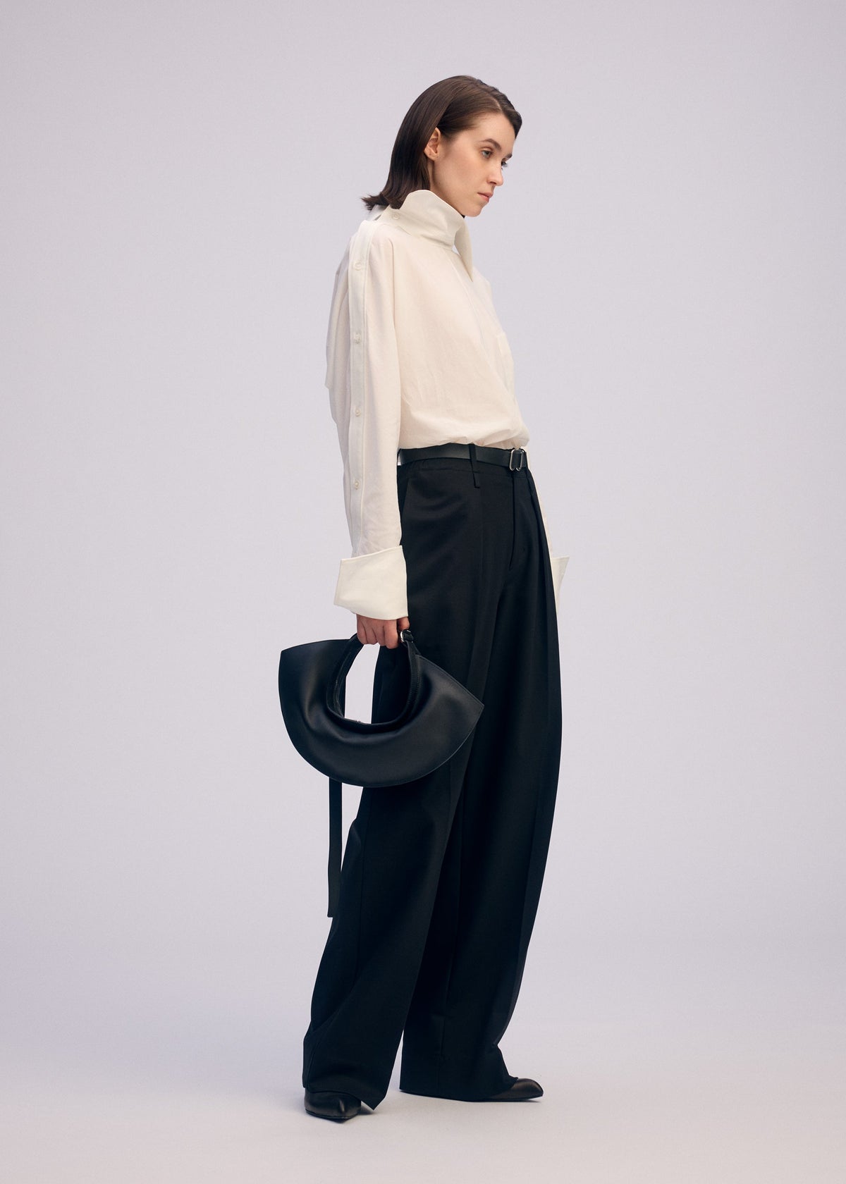 A model wears the ISSEY MIYAKE FIN BAG bags.