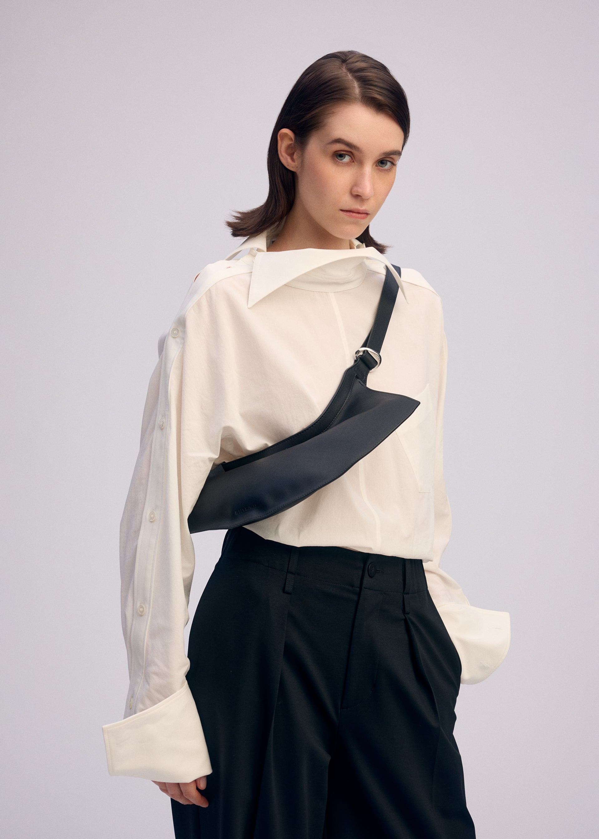 A model wears the ISSEY MIYAKE FIN BAG bags.