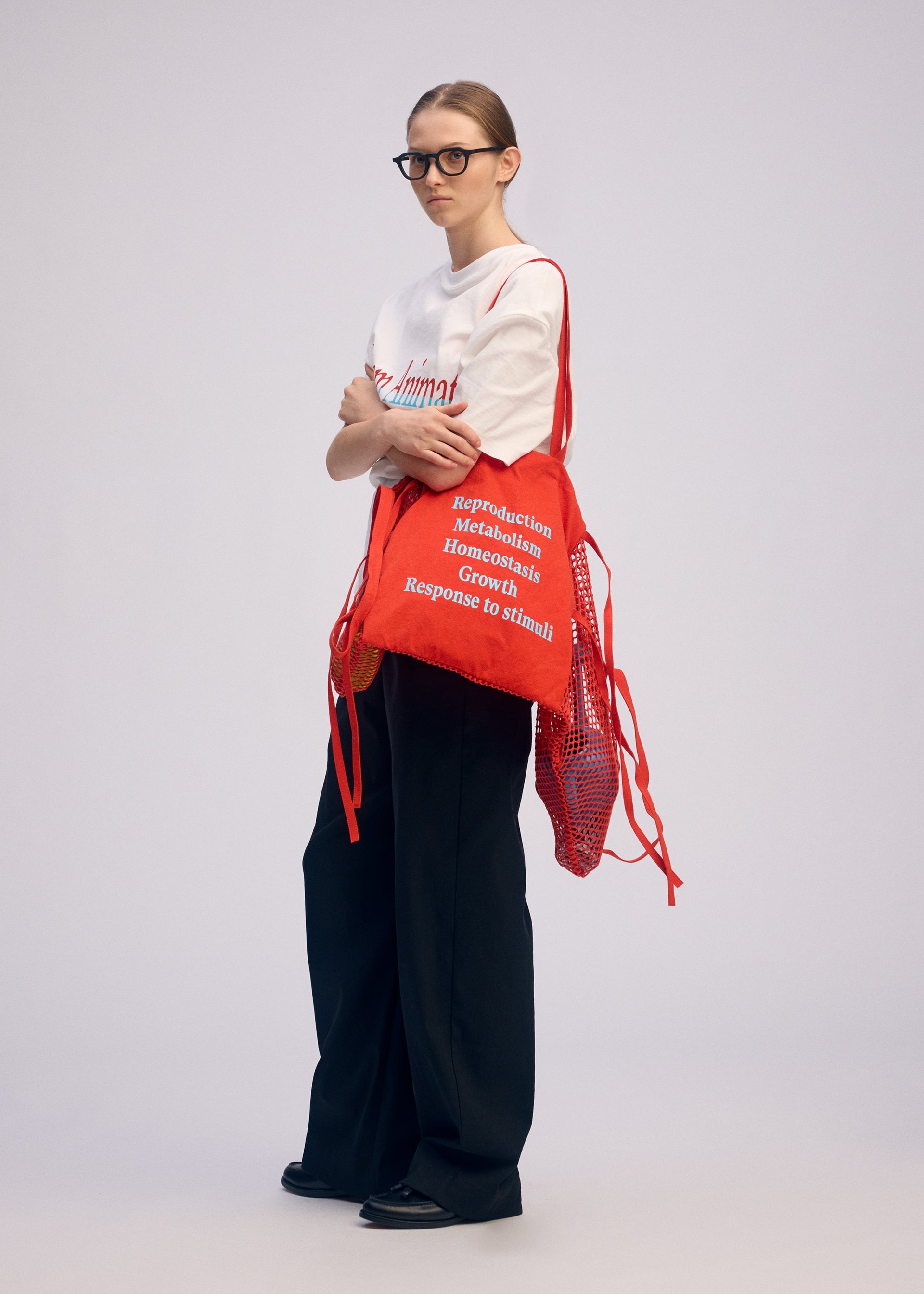 A model wears the ISSEY MIYAKE LIVING TOTE bag.