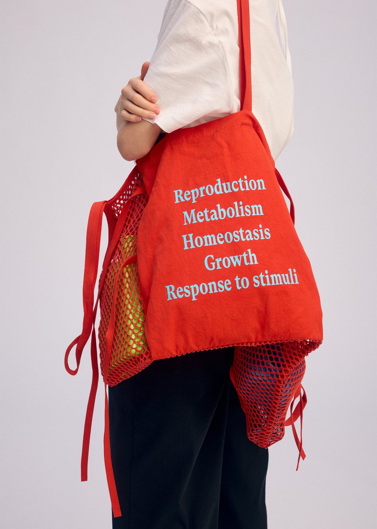 A model wears the ISSEY MIYAKE LIVING TOTE bag.