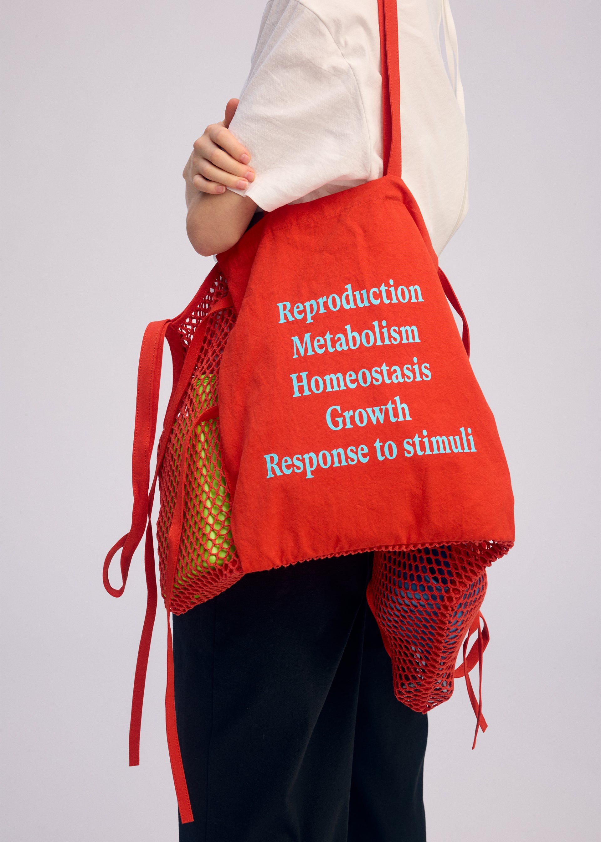 A model wears the ISSEY MIYAKE LIVING TOTE bag.