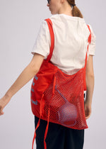 A model wears the ISSEY MIYAKE LIVING TOTE bag.