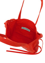 A detail shot of the ISSEY MIYAKE LIVING TOTE bag.