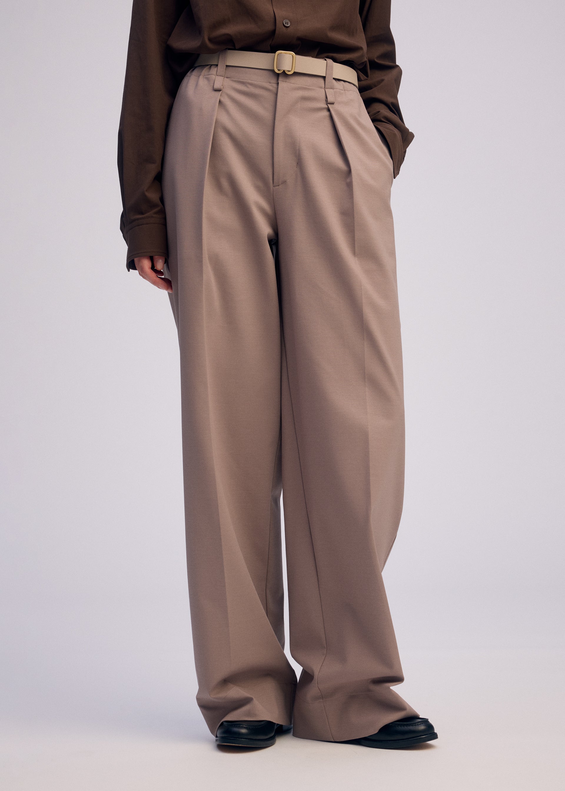 A model wears the ISSEY MIYAKE FORK BELT accessories.