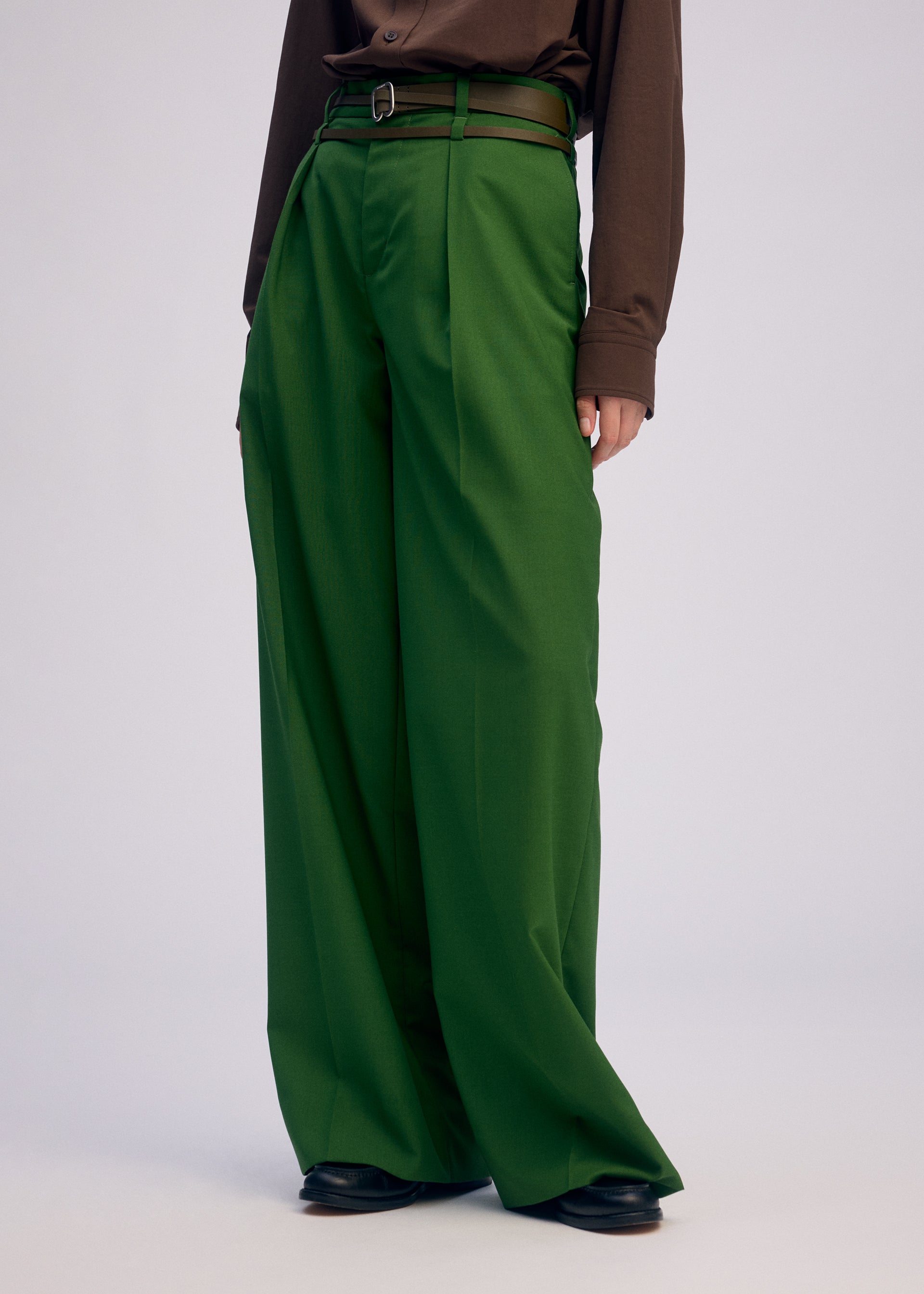 A model wears the ISSEY MIYAKE FORK BELT accessories.