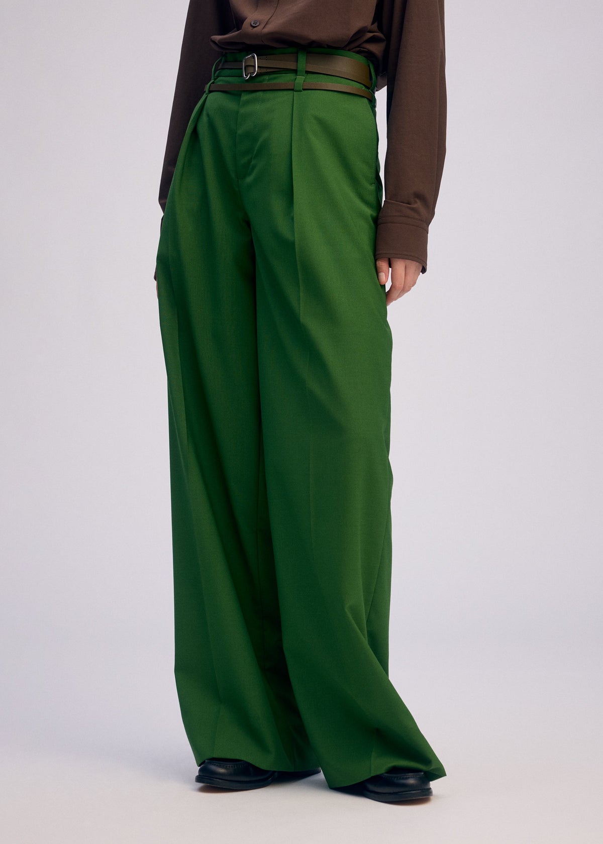 A model wears the ISSEY MIYAKE FORK BELT accessories.