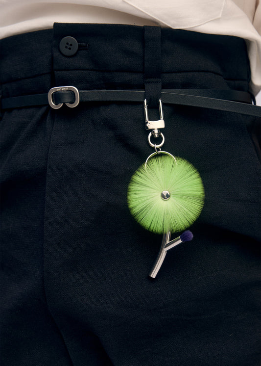 A model wears the ISSEY MIYAKE ENGINEERED FLOWER ACC accessory.