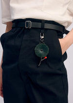 A model wears the ISSEY MIYAKE ENGINEERED FLOWER ACC accessory.