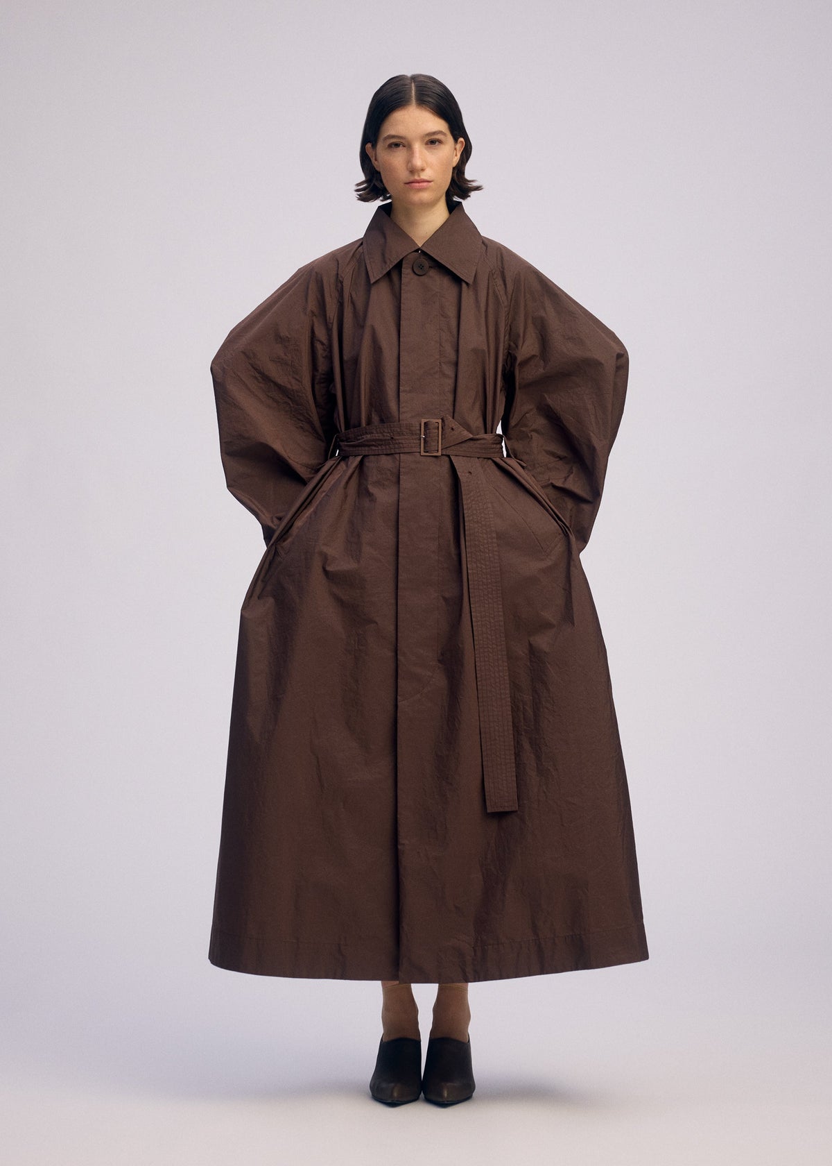 A model wears the ISSEY MIYAKE AKIMBO clothing.