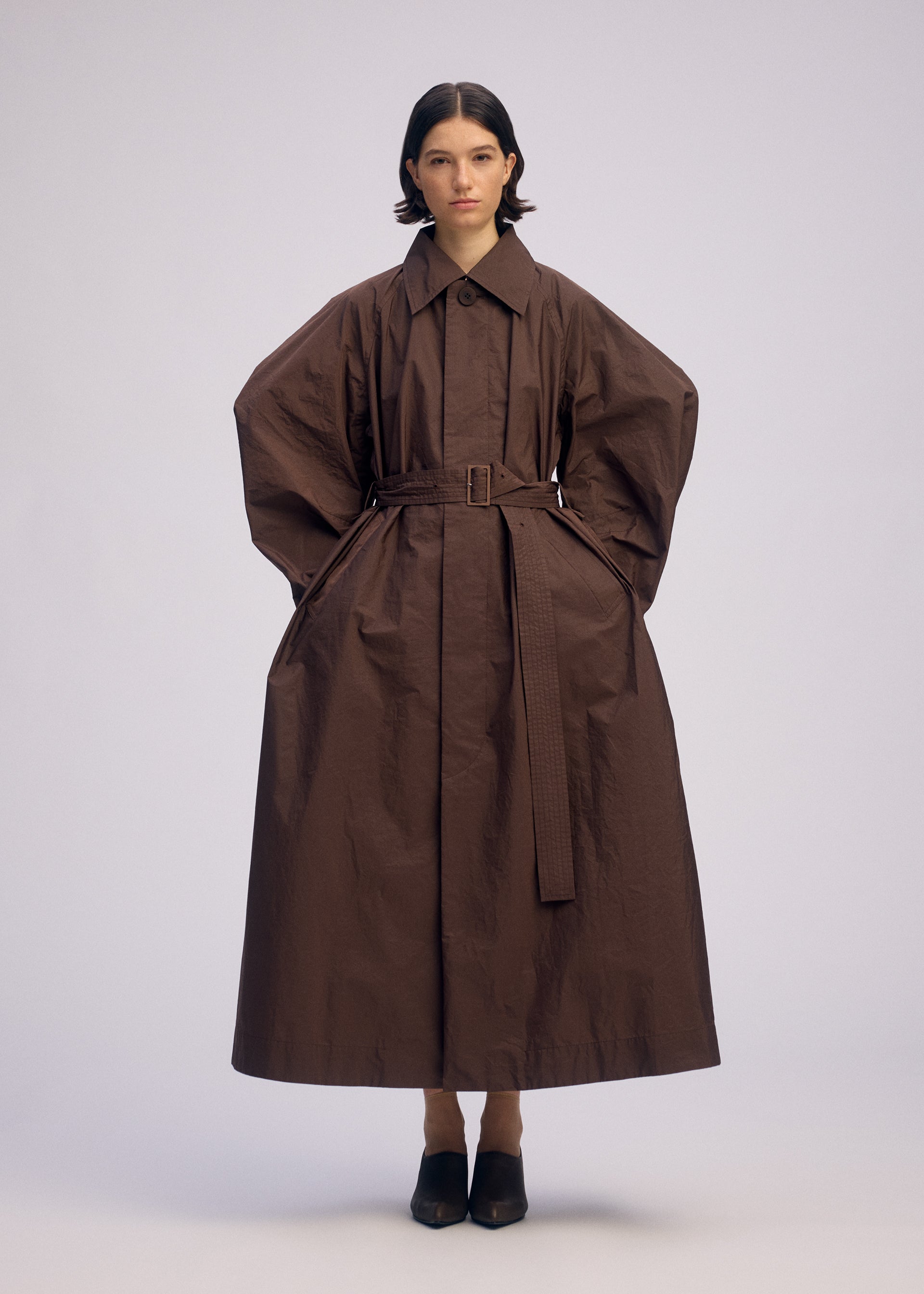 A model wears the ISSEY MIYAKE AKIMBO clothing.