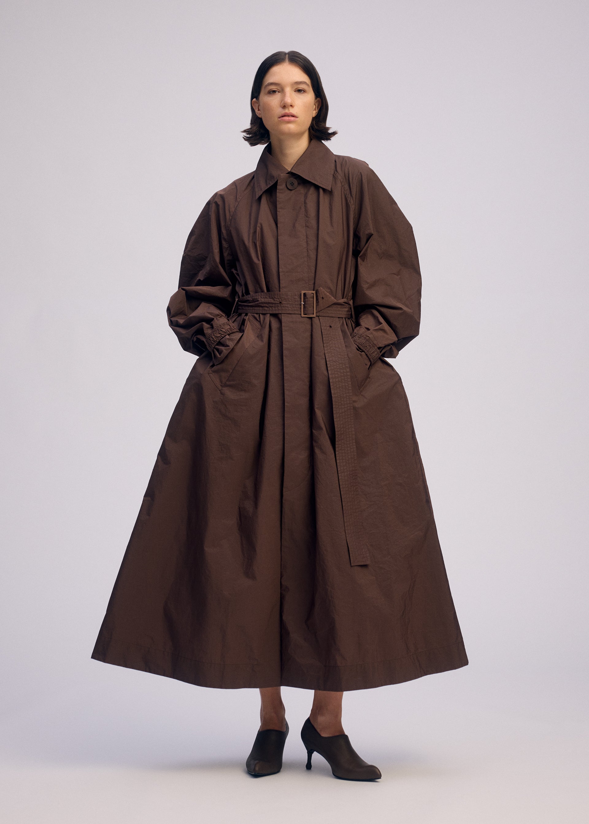 A model wears the ISSEY MIYAKE AKIMBO clothing.