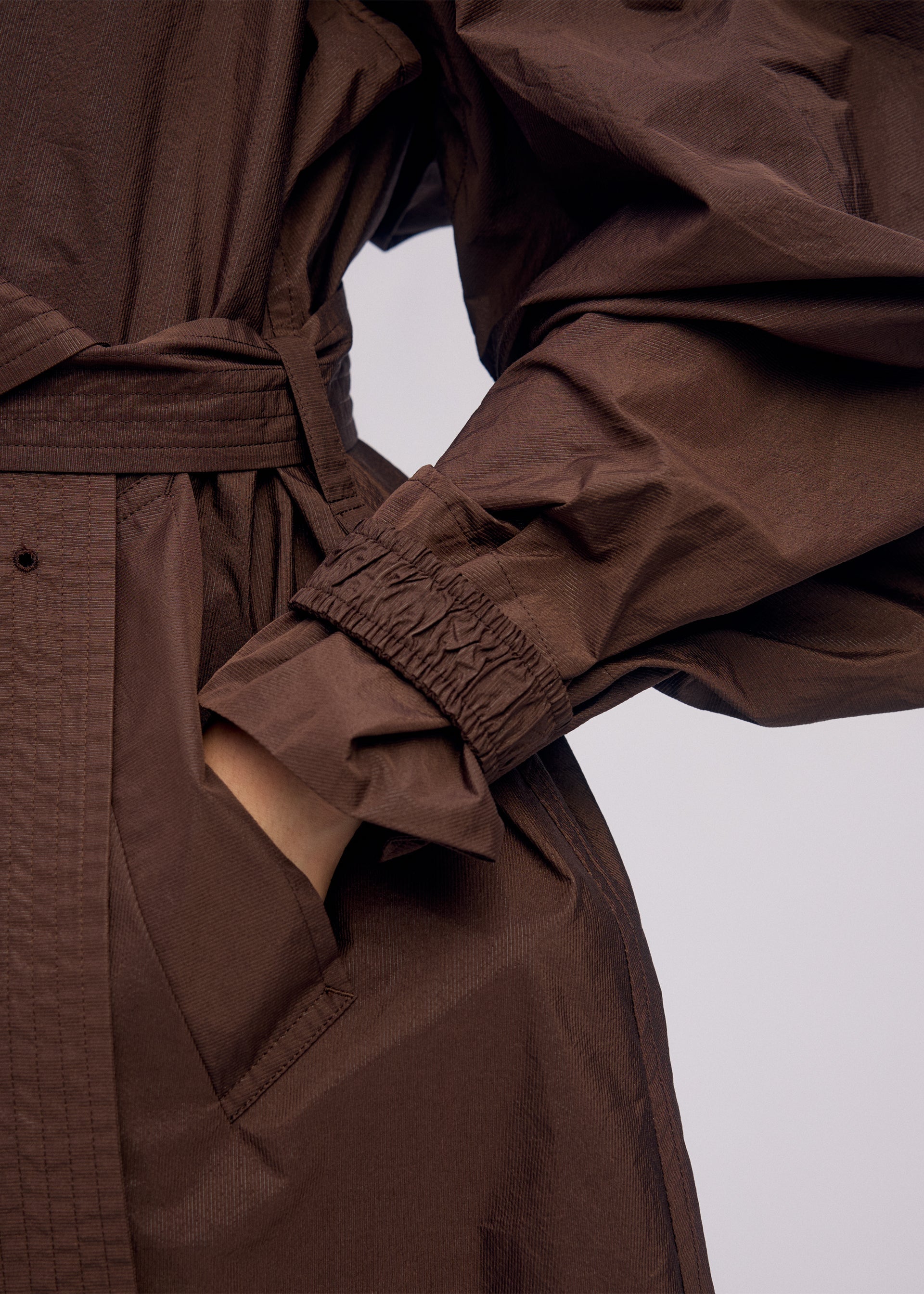 A model wears the ISSEY MIYAKE AKIMBO clothing.