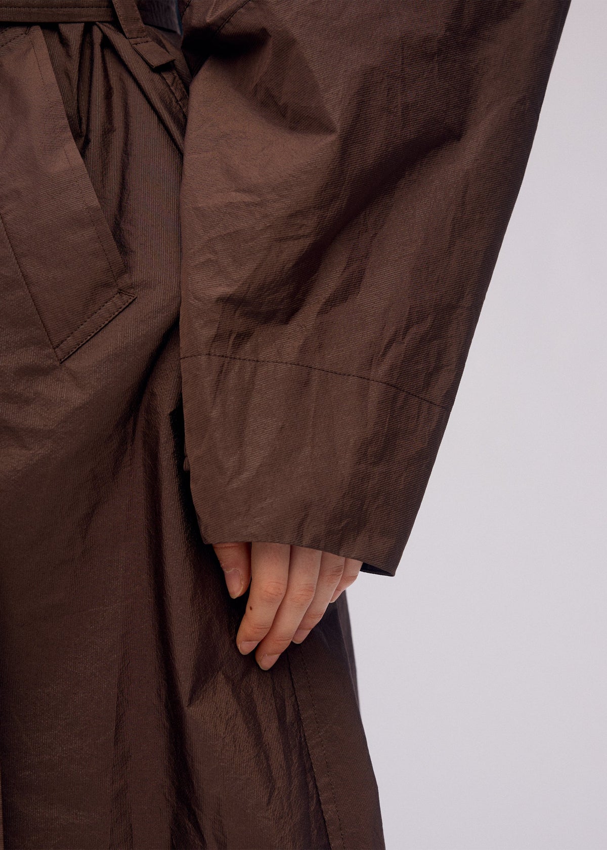 A model wears the ISSEY MIYAKE AKIMBO clothing.