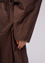 A model wears the ISSEY MIYAKE AKIMBO clothing.