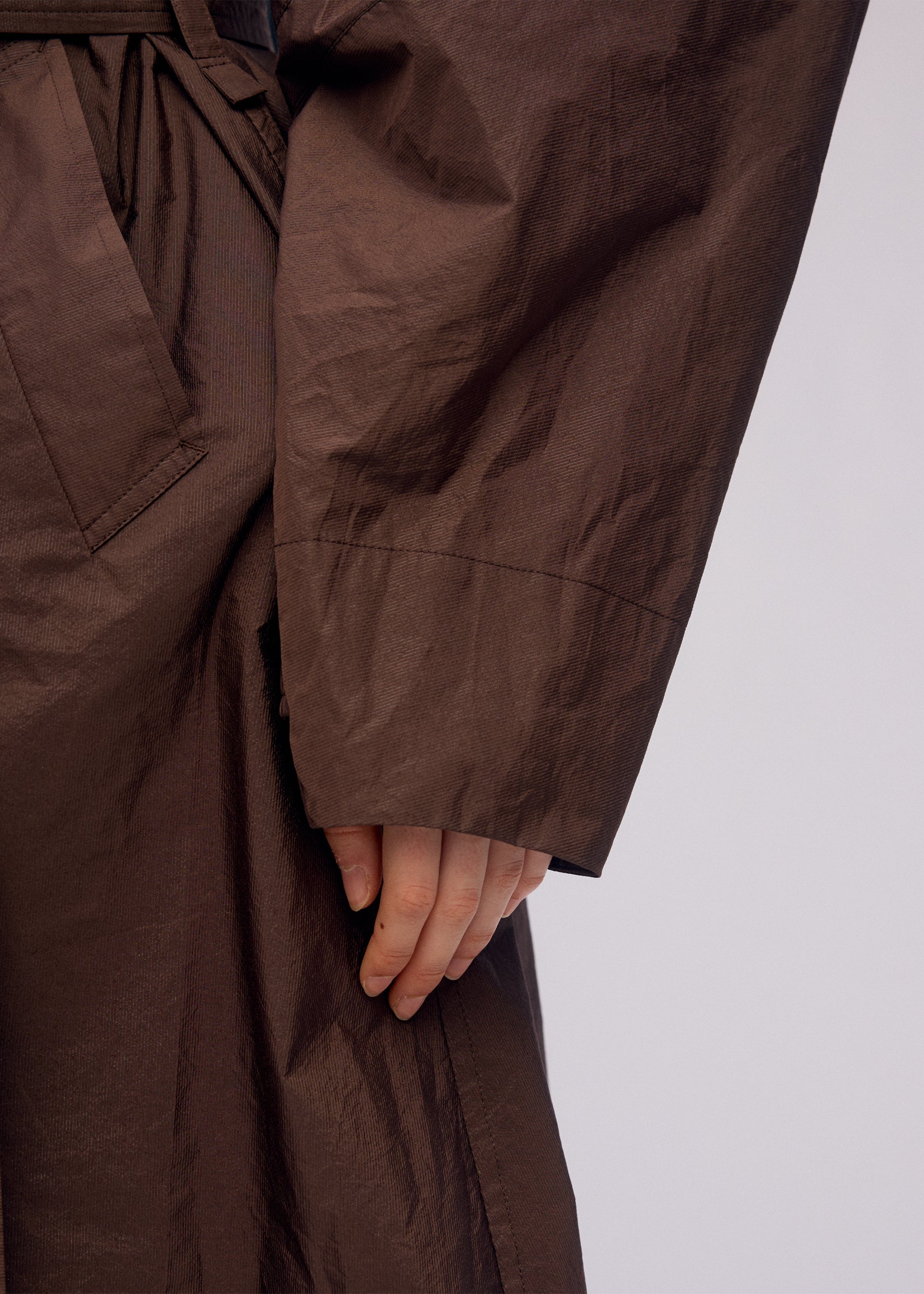 A model wears the ISSEY MIYAKE AKIMBO clothing.