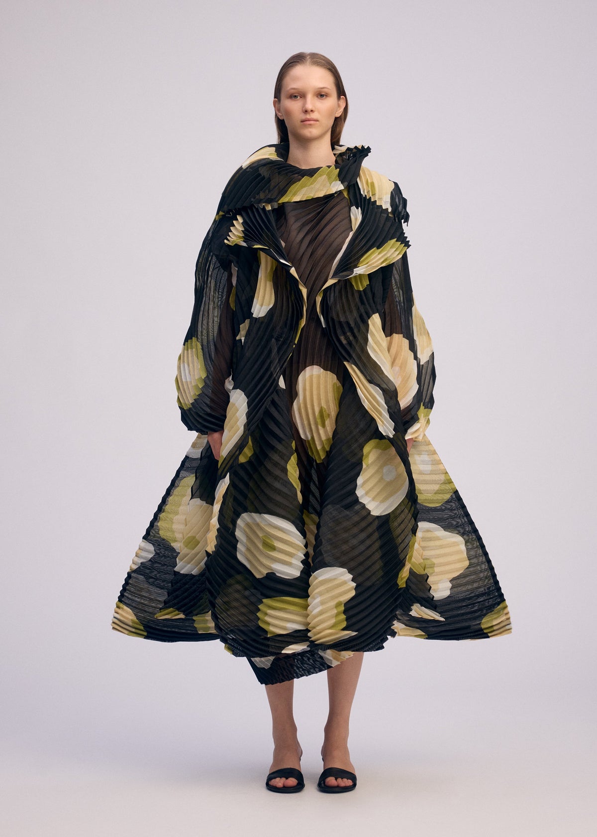 A model wears the ISSEY MIYAKE VERVE coat.