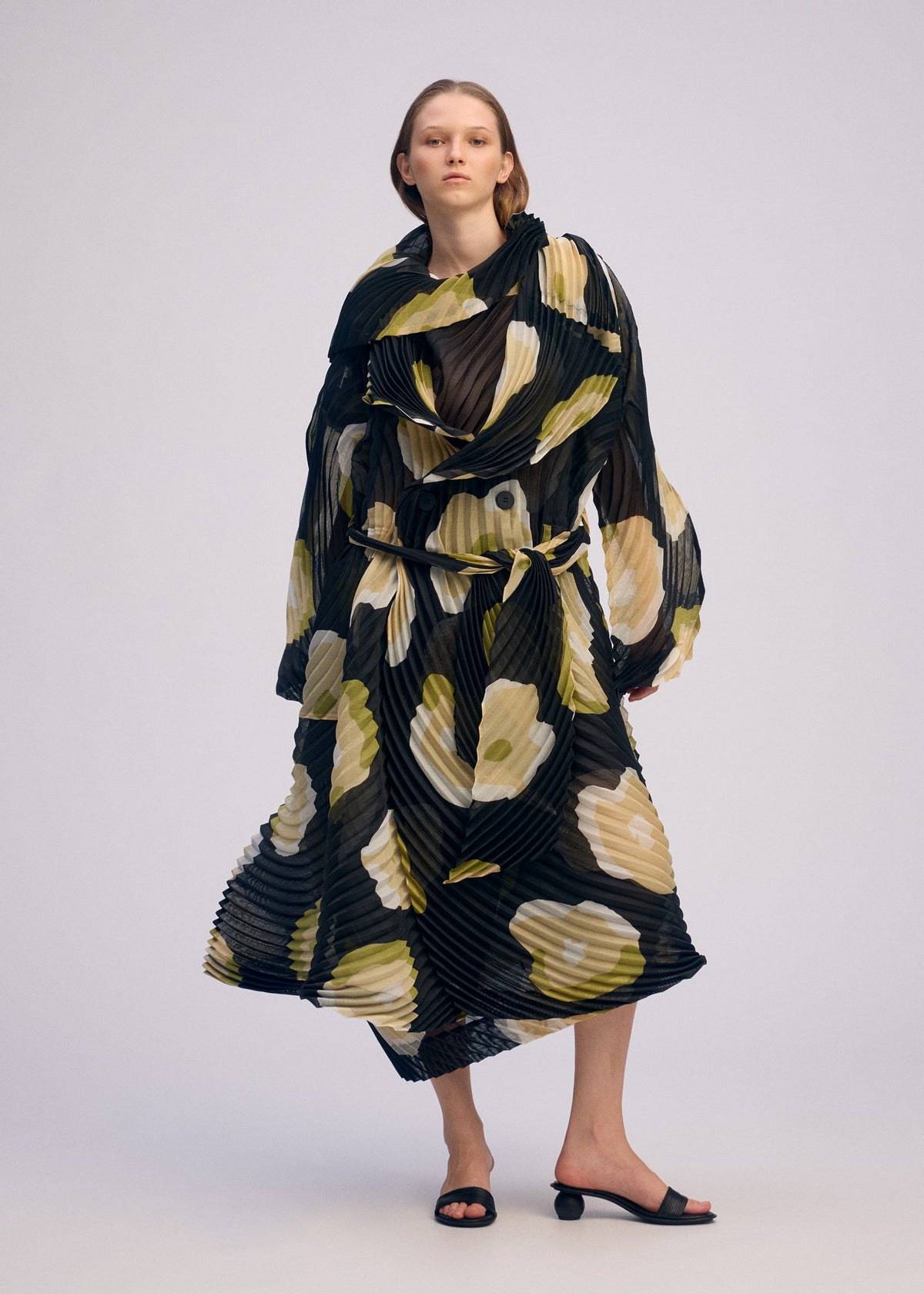 A model wears the ISSEY MIYAKE VERVE coat.