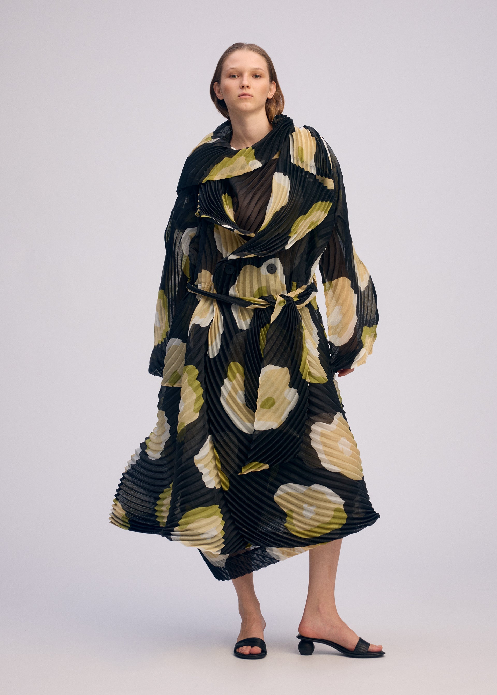 A model wears the ISSEY MIYAKE VERVE coat.