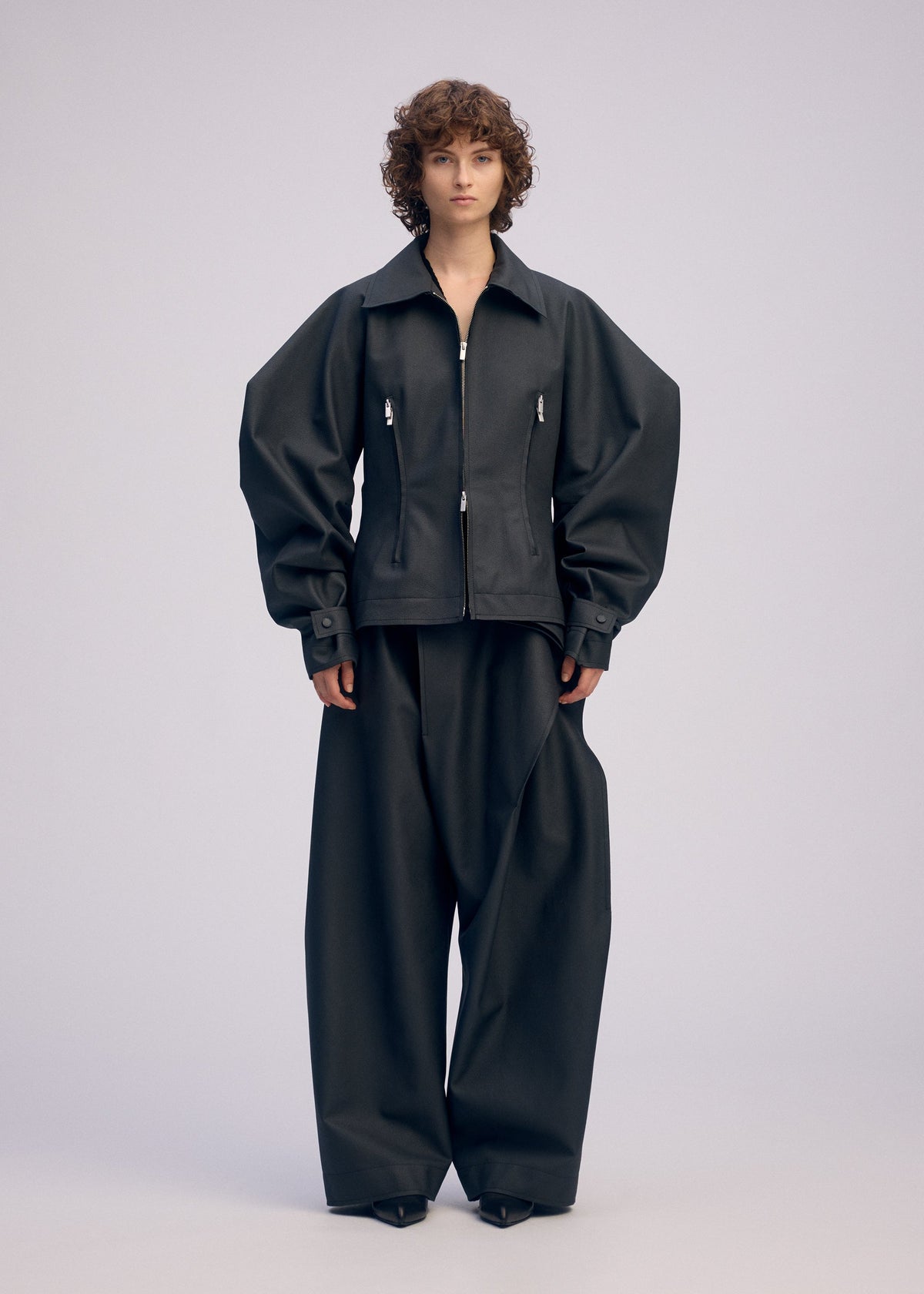 A model wears the ISSEY MIYAKE PRONOUNCED BODY clothing.