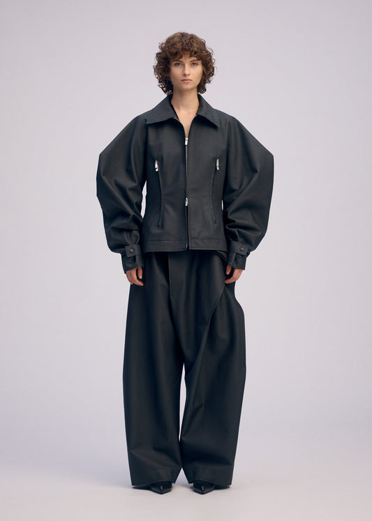 A model wears the ISSEY MIYAKE PRONOUNCED BODY clothing.