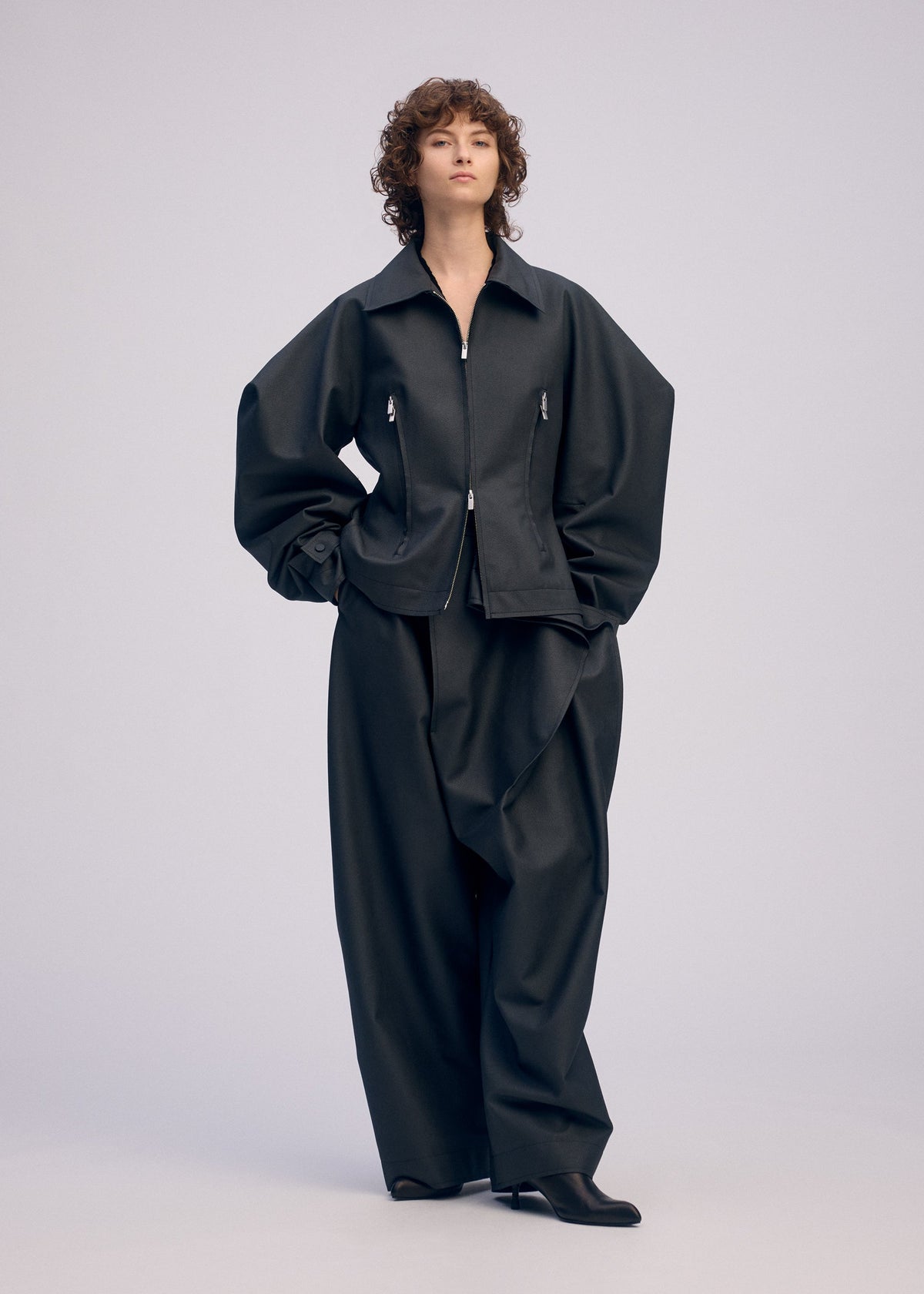 A model wears the ISSEY MIYAKE PRONOUNCED BODY clothing.