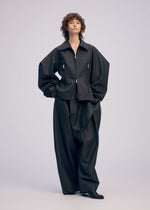 A model wears the ISSEY MIYAKE PRONOUNCED BODY clothing.