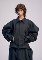 A model wears the ISSEY MIYAKE PRONOUNCED BODY clothing.