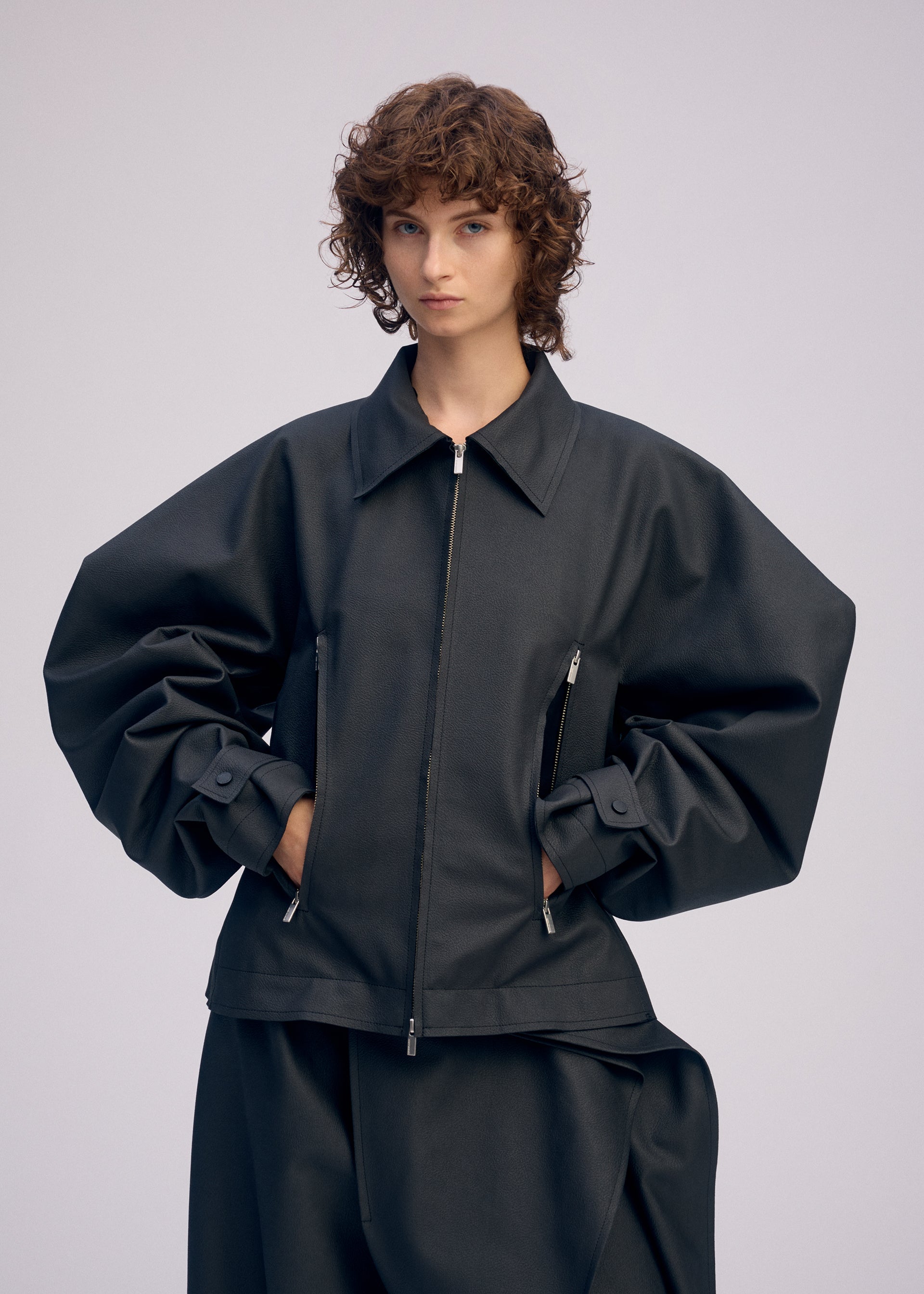 A model wears the ISSEY MIYAKE PRONOUNCED BODY clothing.