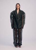 A model wears the ISSEY MIYAKE DRAW TO FORM jacket.