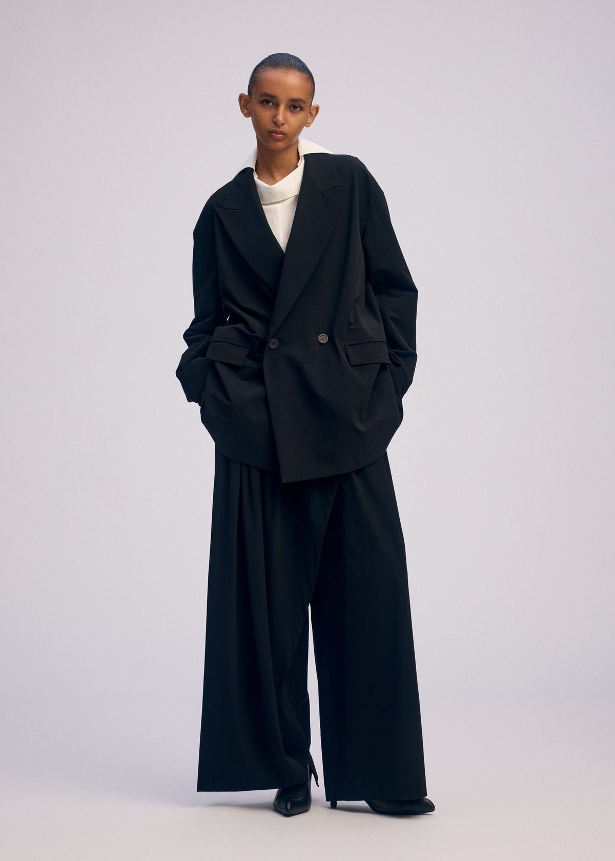 A model wears the ISSEY MIYAKE LOOPED jacket.