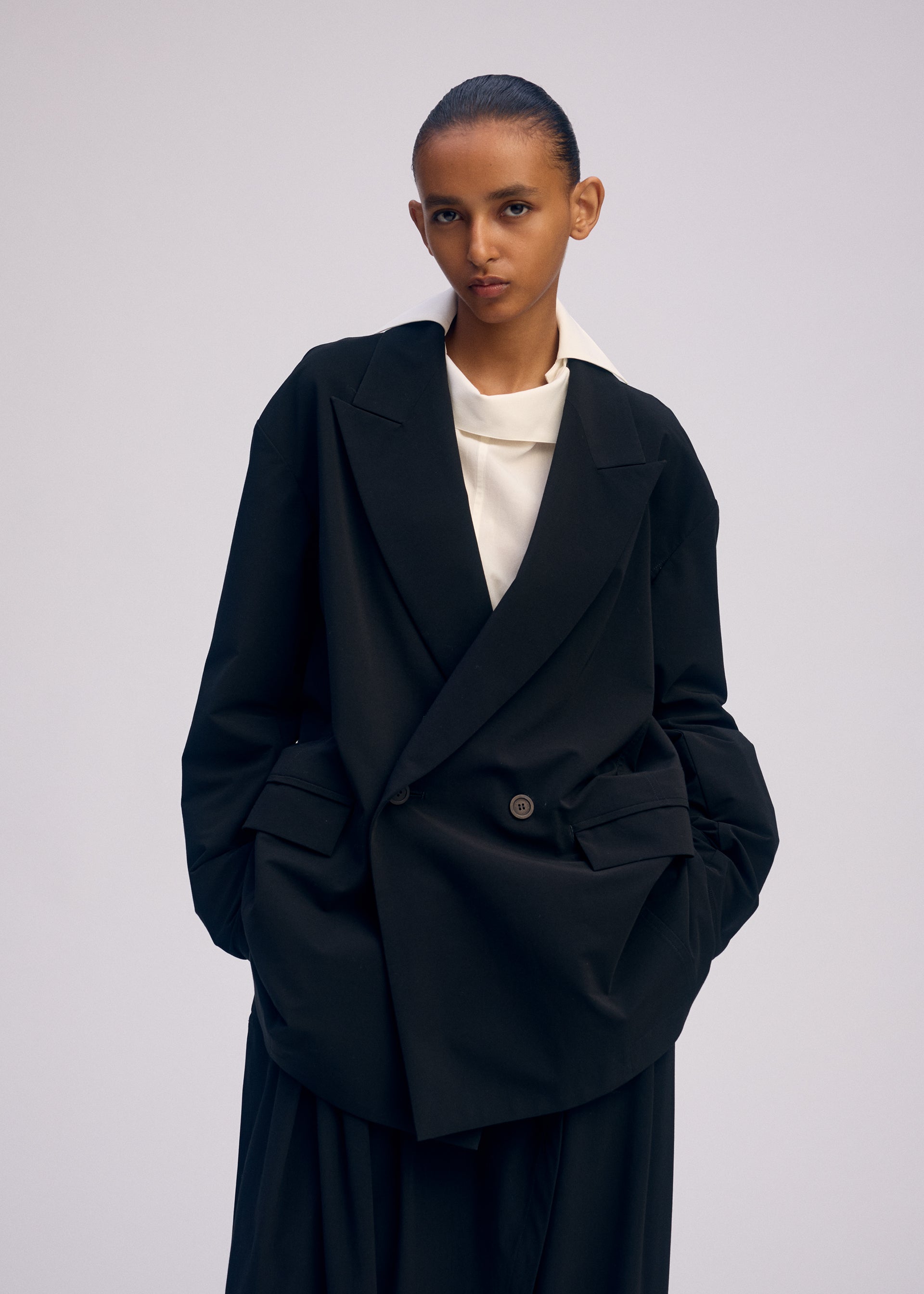 A model wears the ISSEY MIYAKE LOOPED jacket.