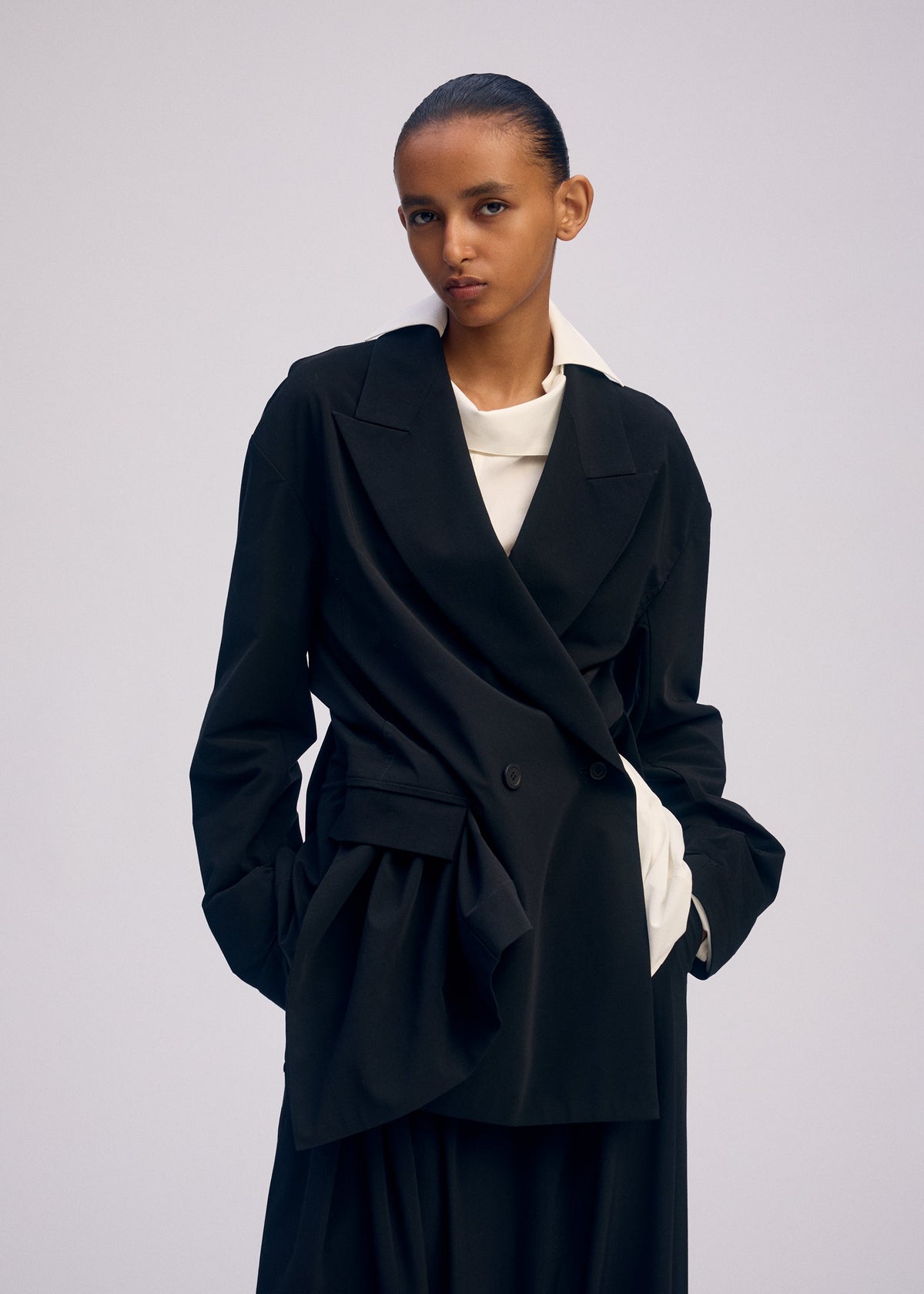 A model wears the ISSEY MIYAKE LOOPED jacket.