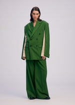 A model wears the ISSEY MIYAKE PALINDROME jacket.