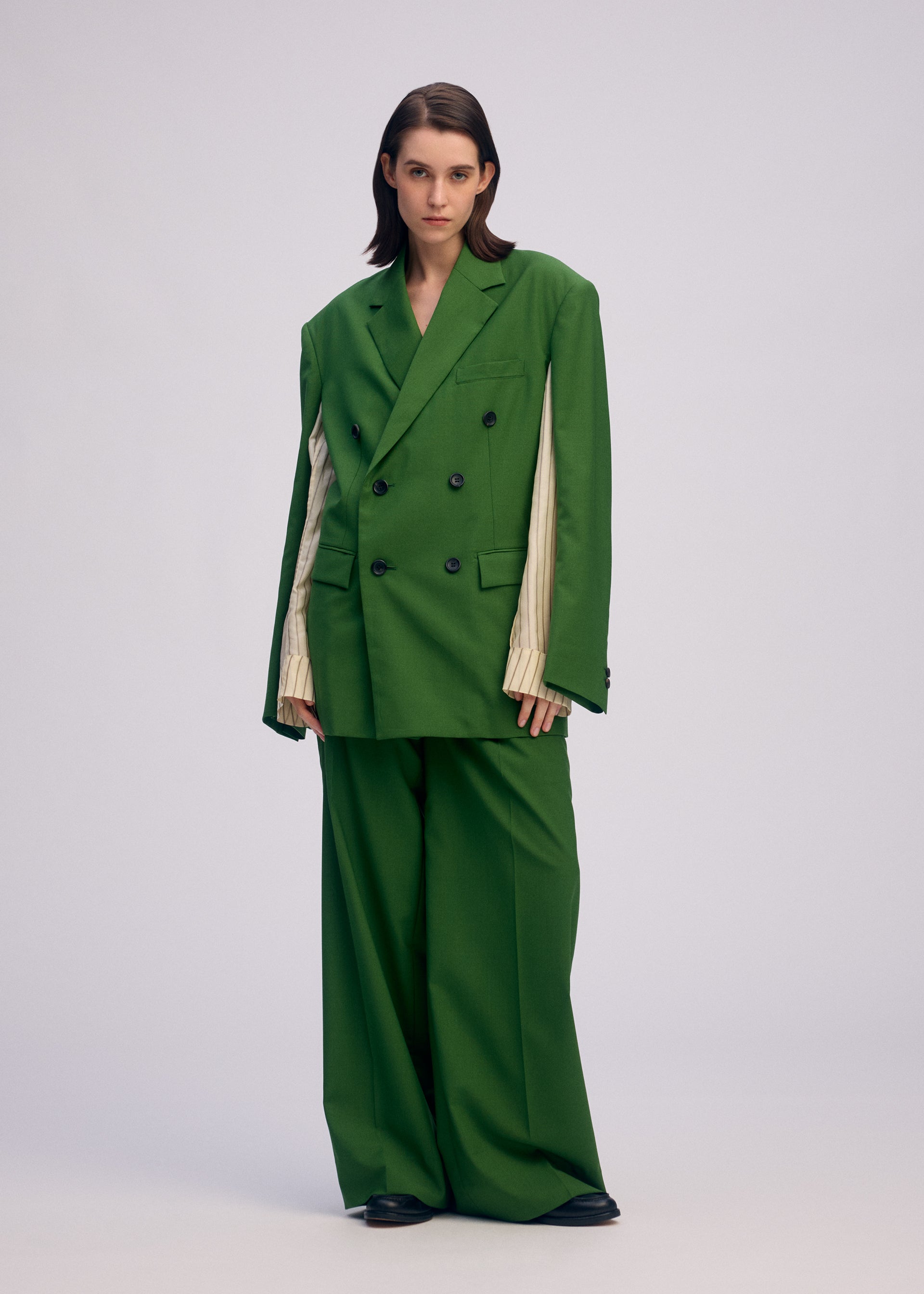 A model wears the ISSEY MIYAKE PALINDROME jacket.