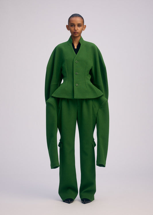 A model wears the ISSEY MIYAKE ARMS clothing.