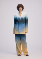 A model wears the ISSEY MIYAKE PLUMAGE plumage-jacket-chukar.
