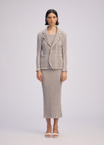 A model wears the ISSEY MIYAKE WAVELET ENSEMBLE jacket.
