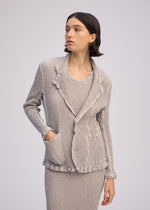 A model wears the ISSEY MIYAKE WAVELET ENSEMBLE jacket.