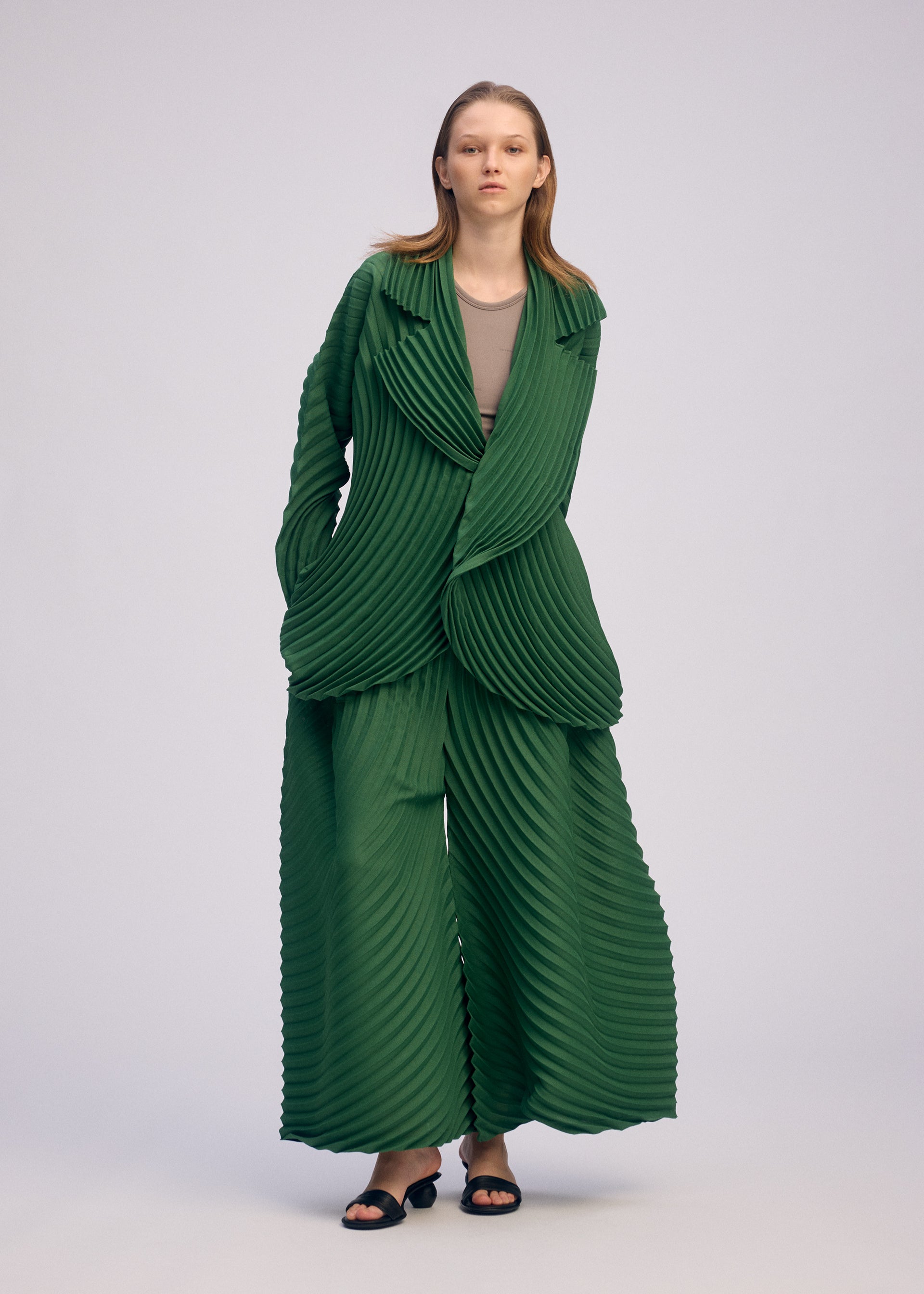 A model wears the ISSEY MIYAKE CIRCLE PLEATS PB jacket.