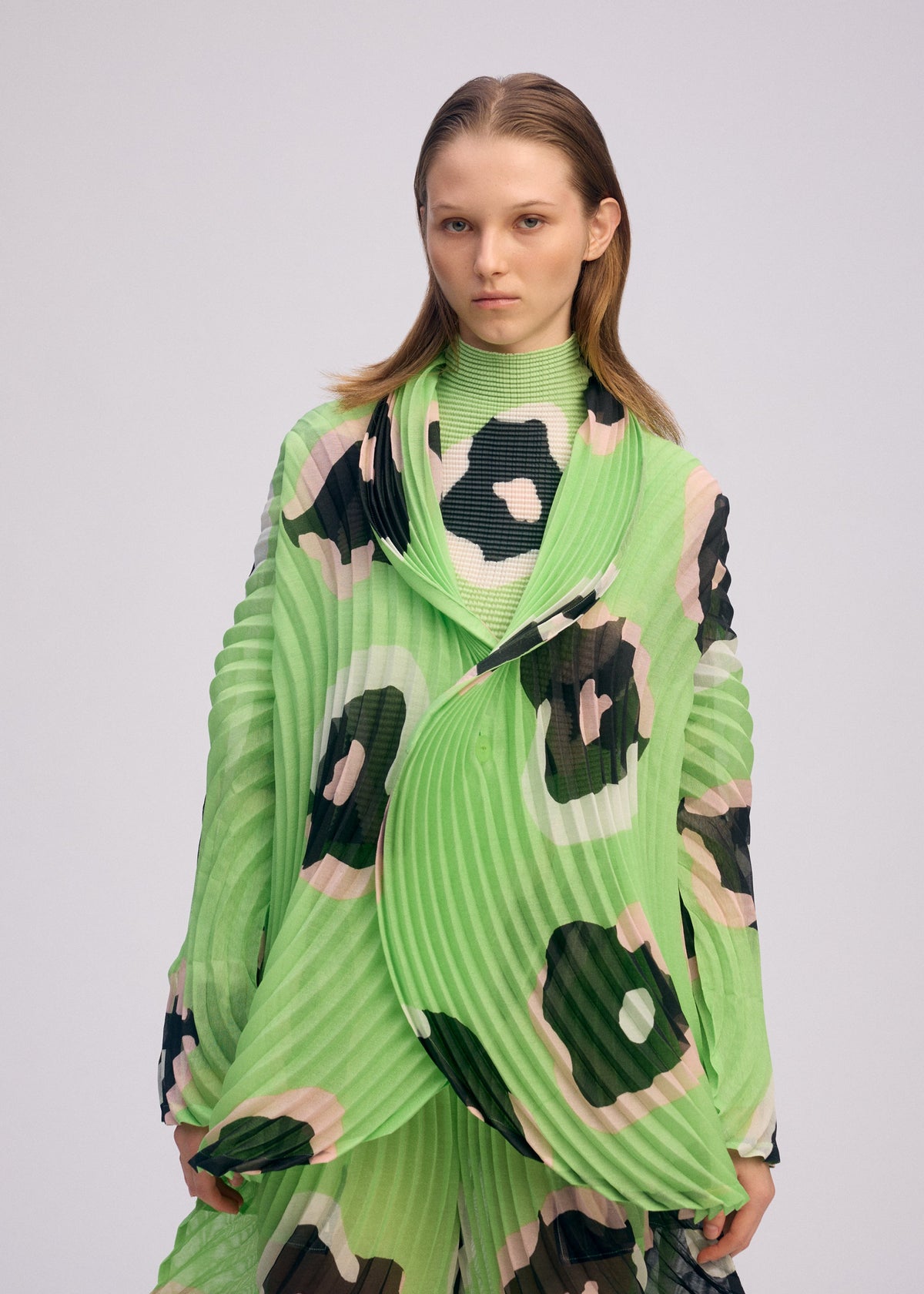 A model wears the ISSEY MIYAKE VERVE jacket.