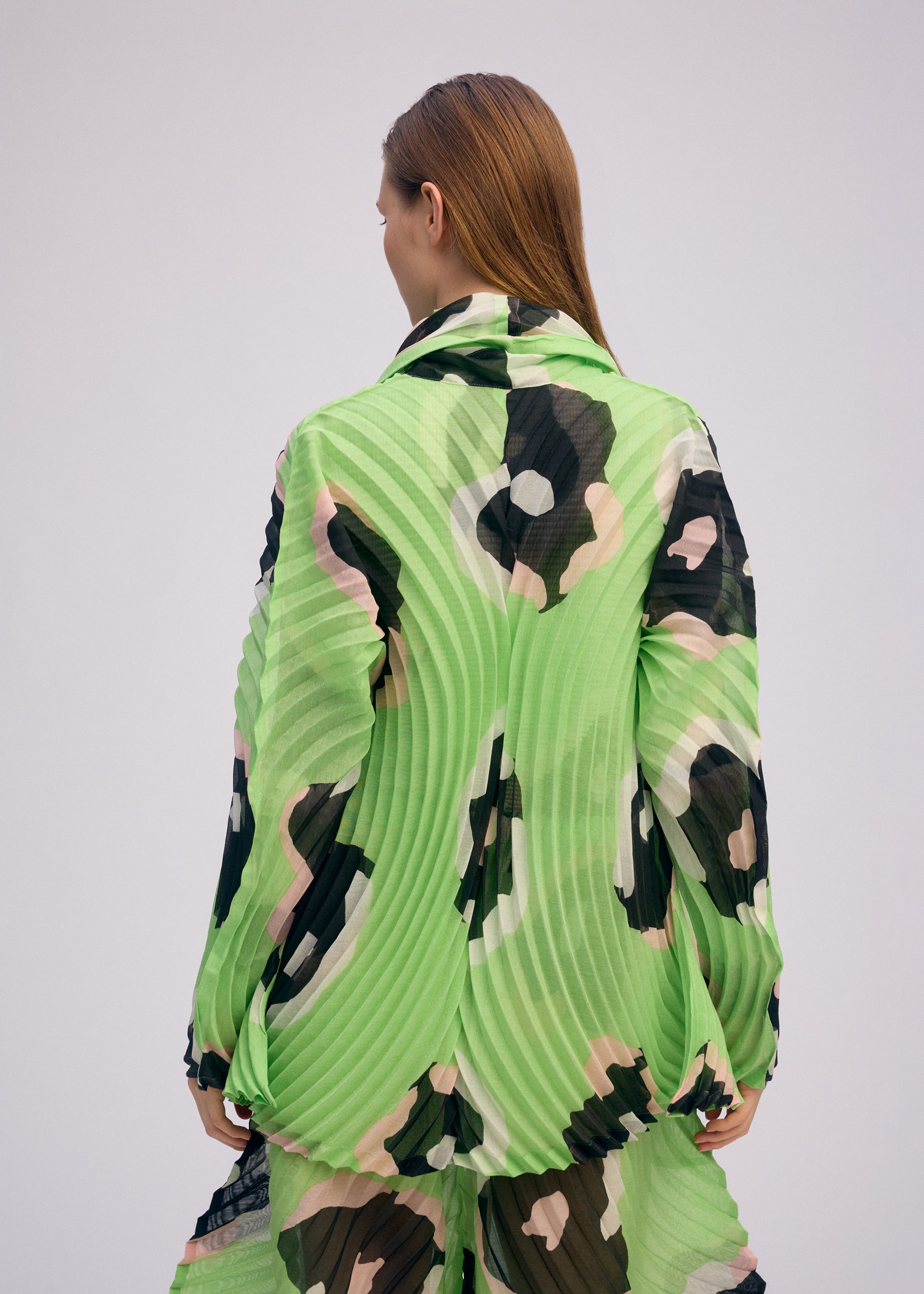 A model wears the ISSEY MIYAKE VERVE jacket.