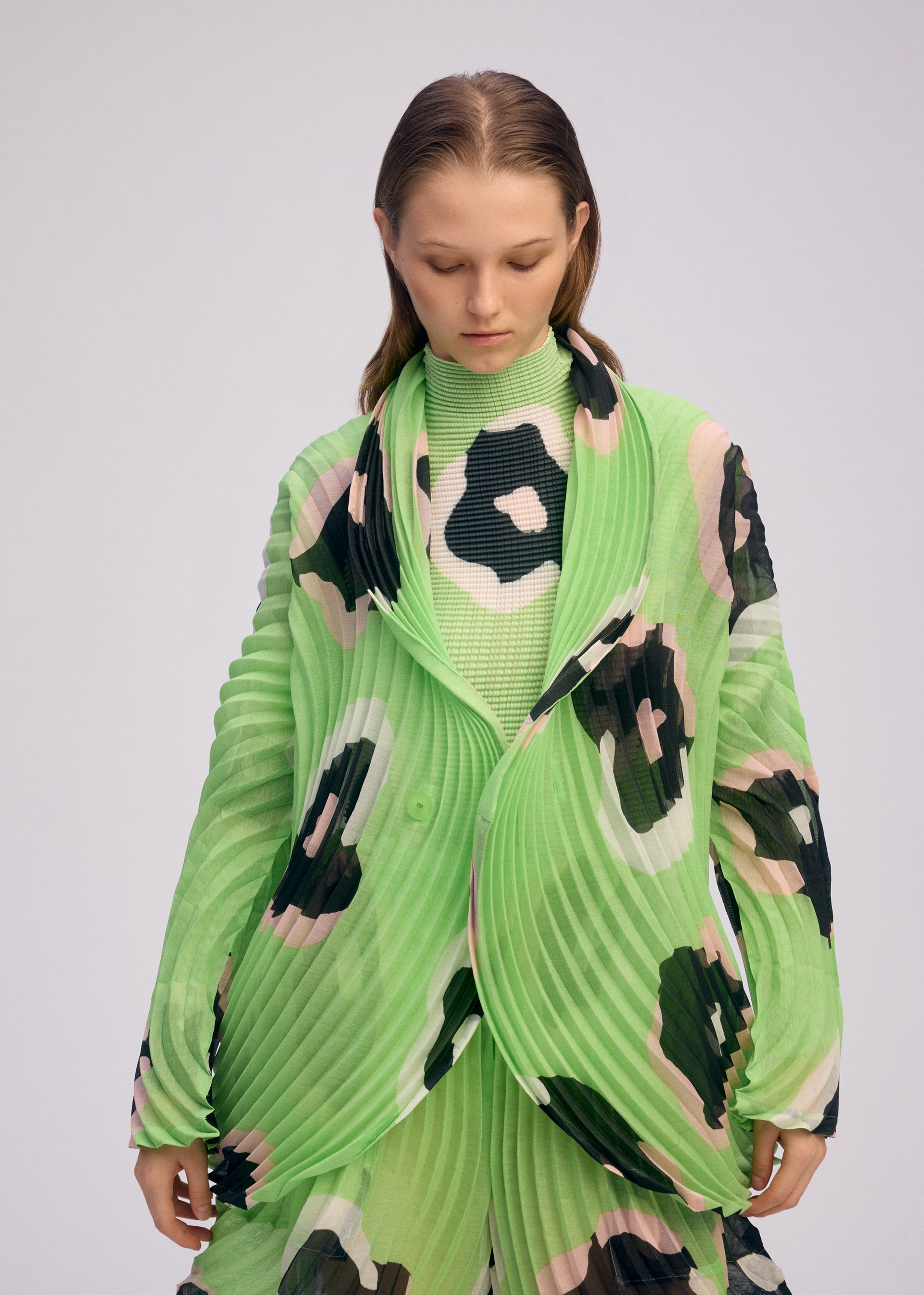 A model wears the ISSEY MIYAKE VERVE jacket.