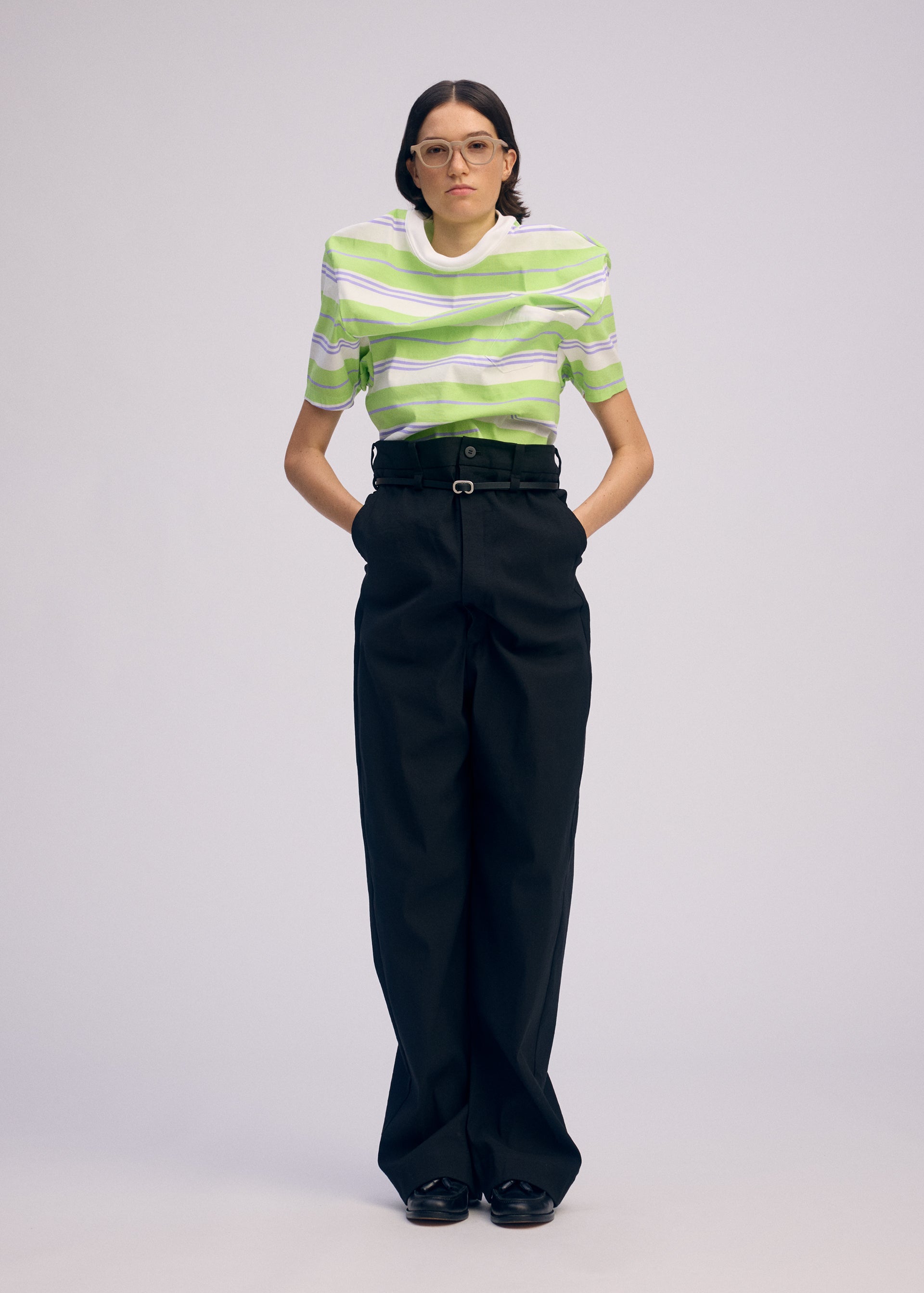 A model wears the ISSEY MIYAKE GENERIC WEAR trousers.
