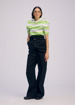 A model wears the ISSEY MIYAKE GENERIC WEAR trousers.