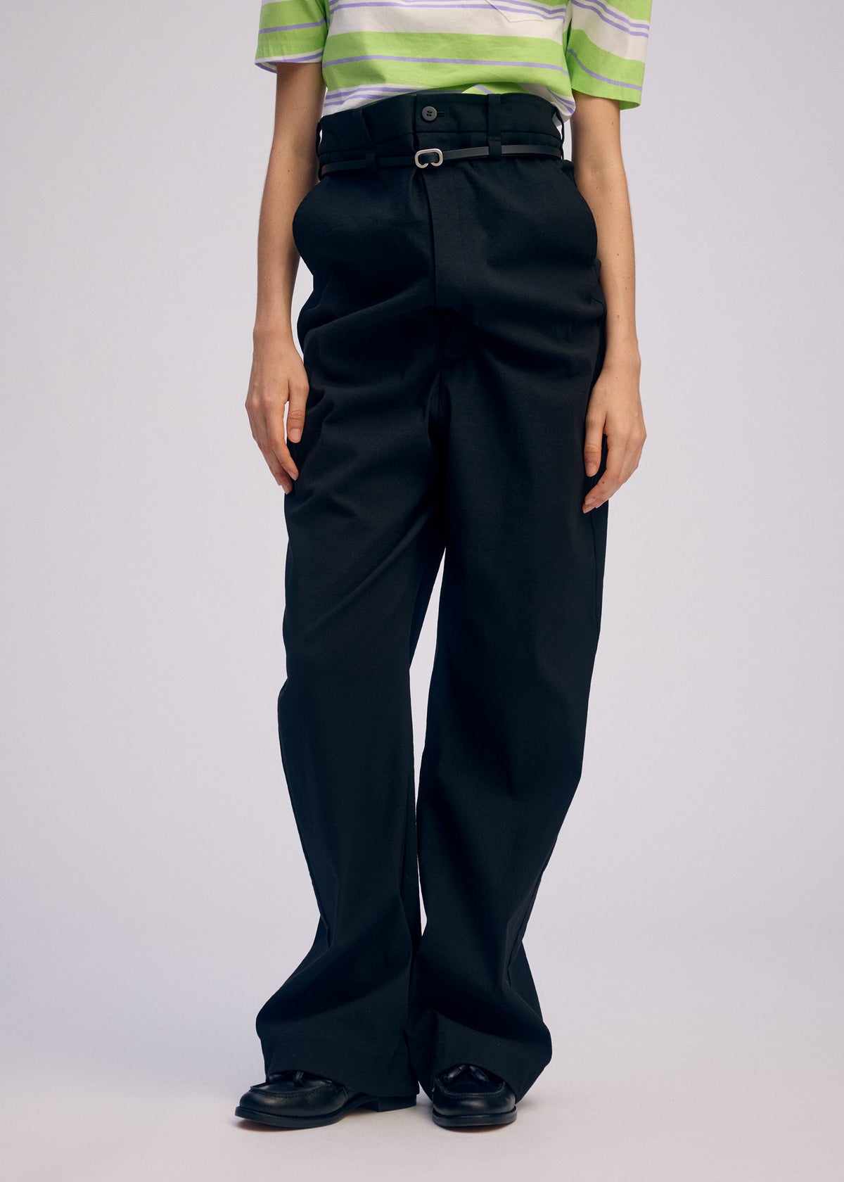 A model wears the ISSEY MIYAKE GENERIC WEAR trousers.