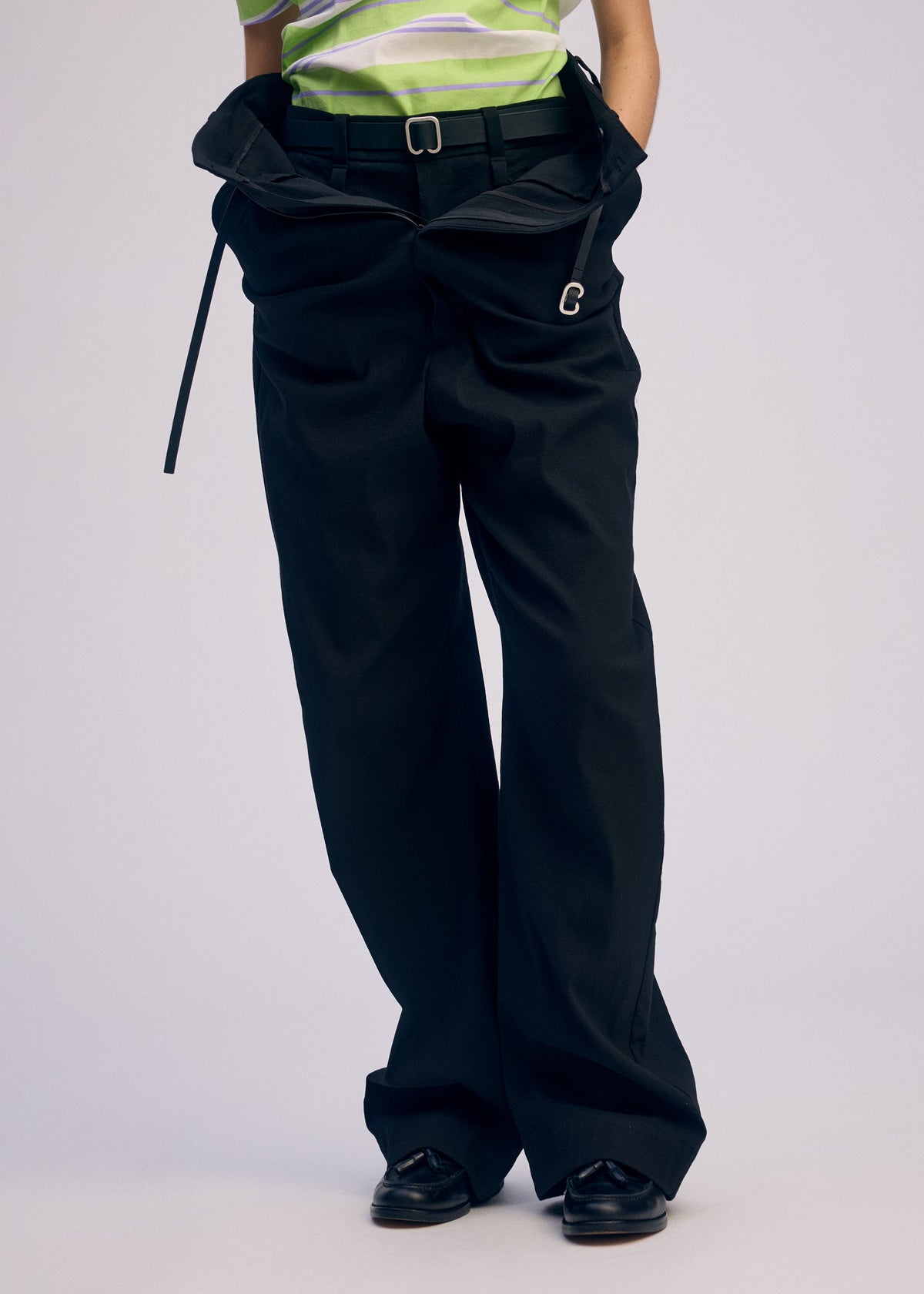 A model wears the ISSEY MIYAKE GENERIC WEAR trousers.