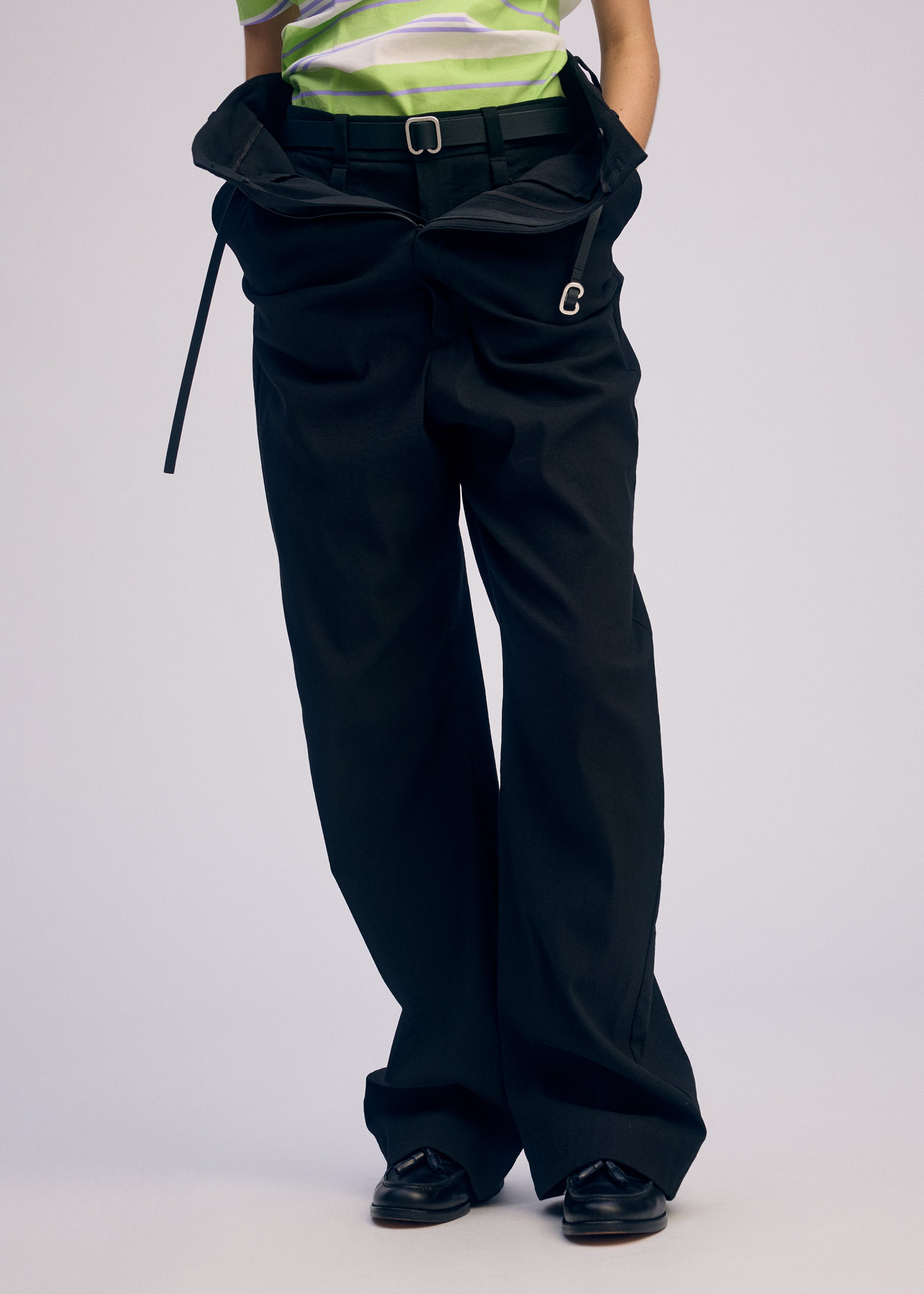 A model wears the ISSEY MIYAKE GENERIC WEAR trousers.
