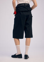 A model wears the ISSEY MIYAKE GENERIC WEAR trousers.