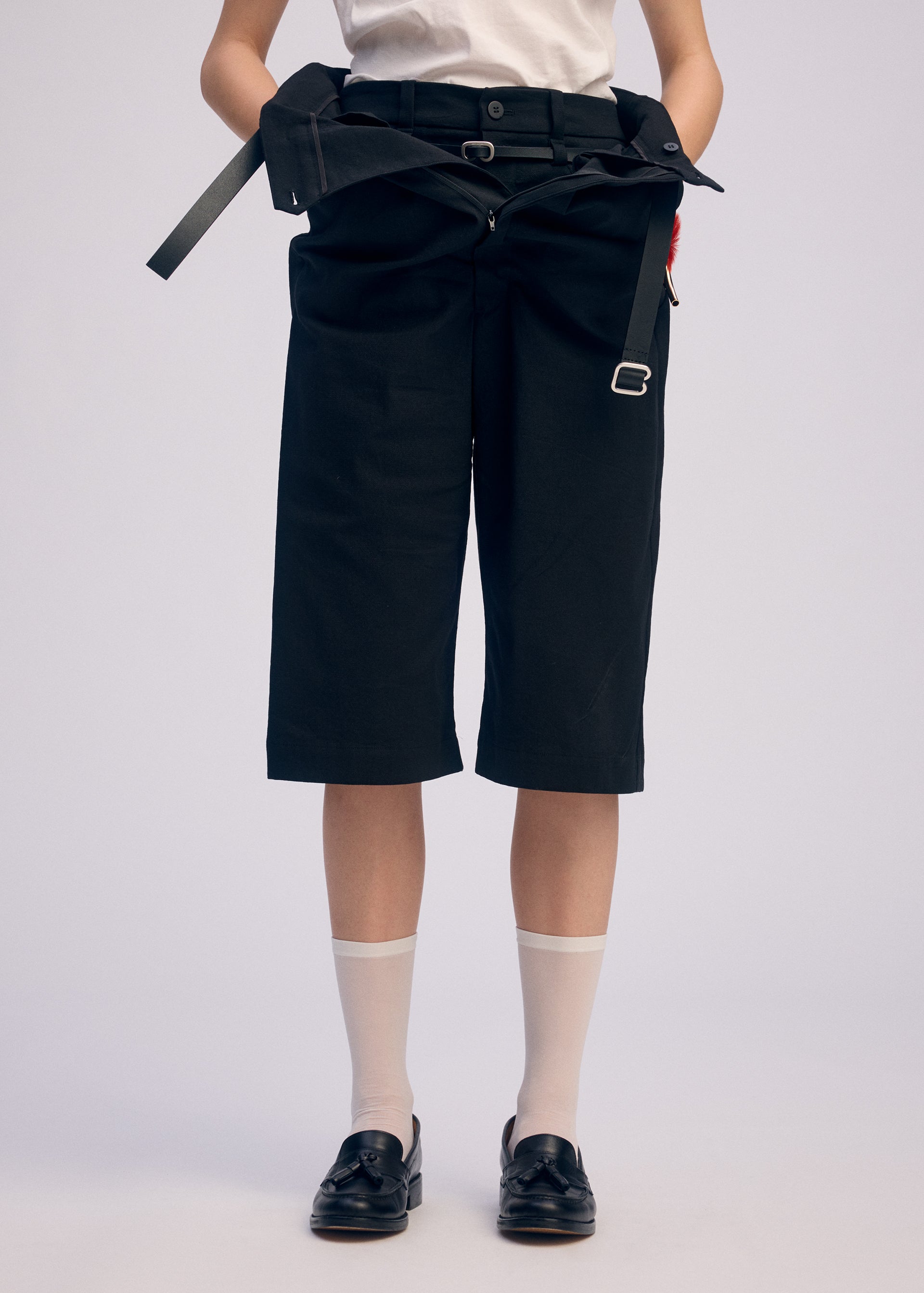 A model wears the ISSEY MIYAKE GENERIC WEAR trousers.