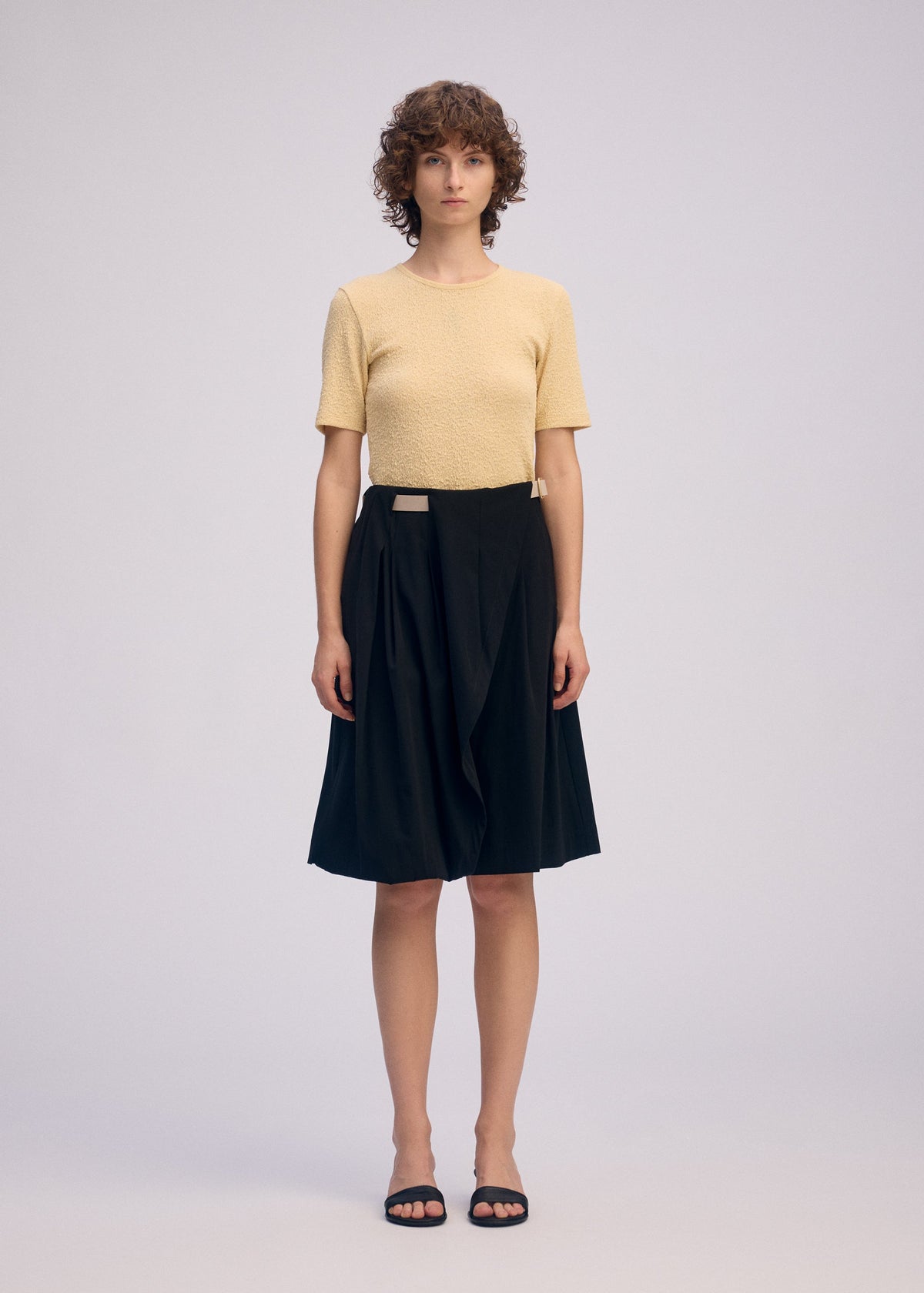 A model wears the ISSEY MIYAKE LOOPED trousers.